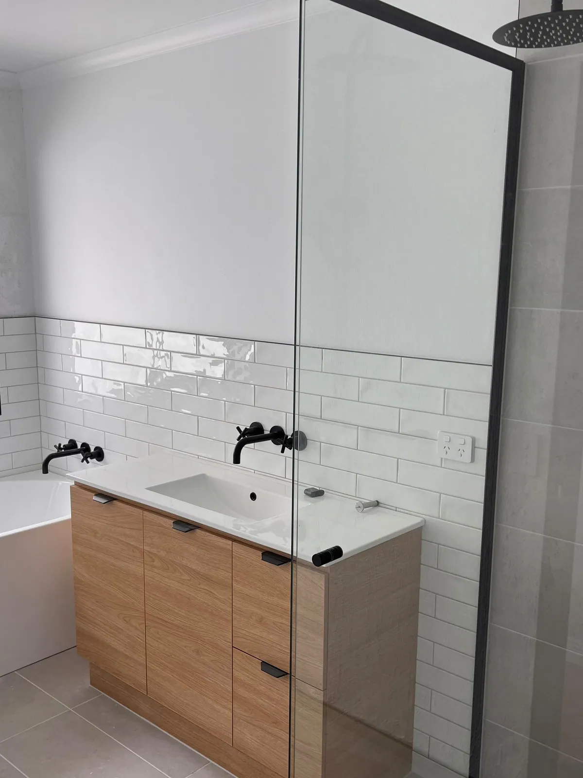 Bathroom with freshly painted white walls and ceiling above the tiles